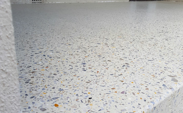 A light sandy aggregate concrete patio